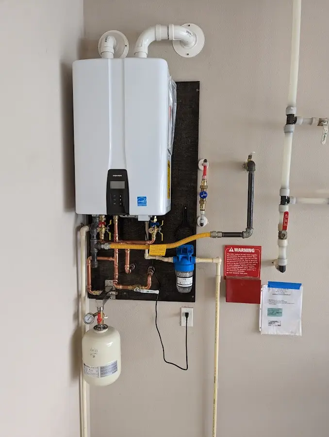 Professional plumber installing copper piping in a Jenkins home